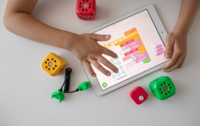 Child's hands programming on tablet