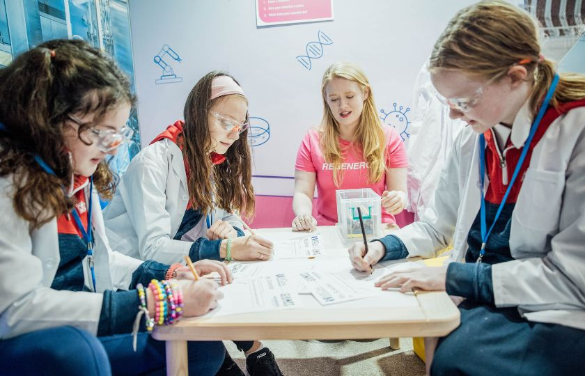 Future Scientists busy at the exhibition with a Regeneron Volunteer