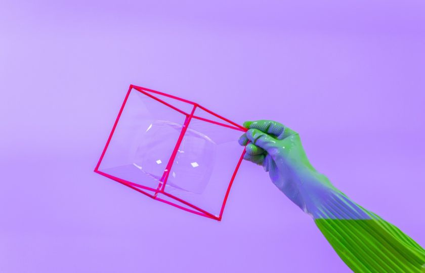 Red cube made from straws with a circular bubble inside it